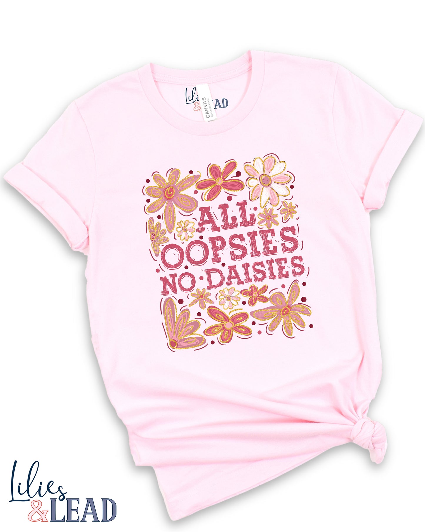 Light pink tee with saying All Oopsies No Daisies surrounded by florals in pink and white
