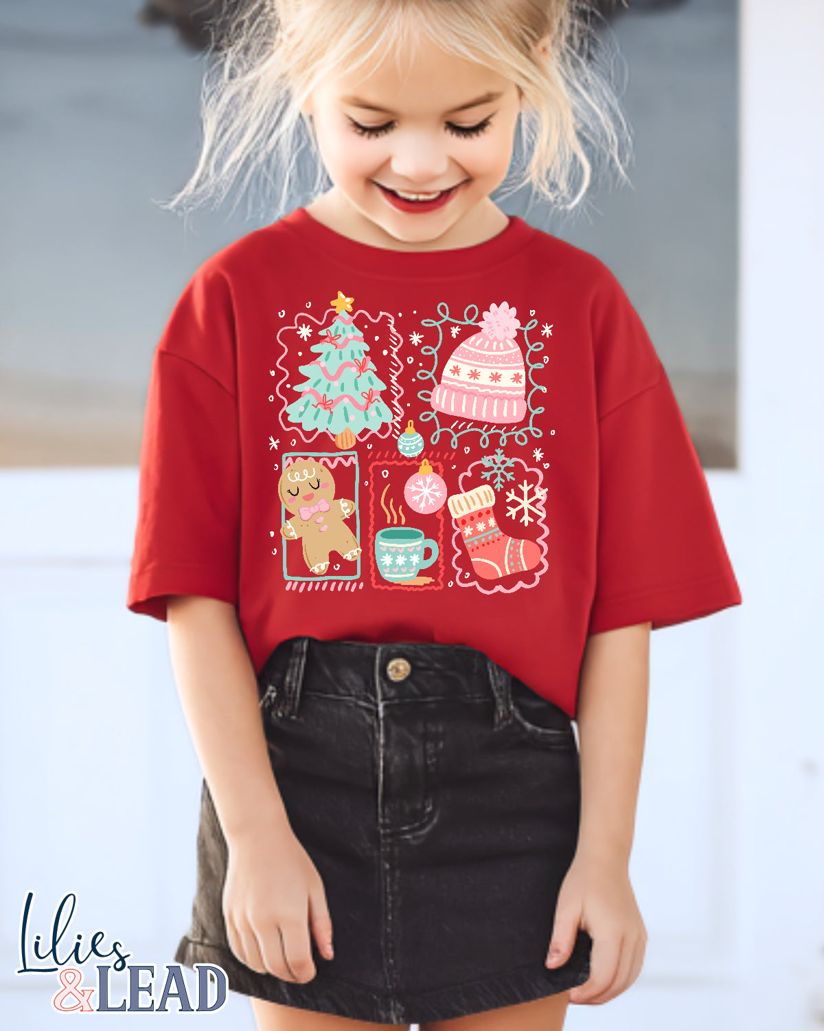 Child wearing a red Christmas-themed shirt with a blurred background