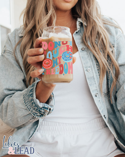 16oz glass can with retro font saying "donut touch my freedom" featuring donut graphics in variations of red, white and blue.