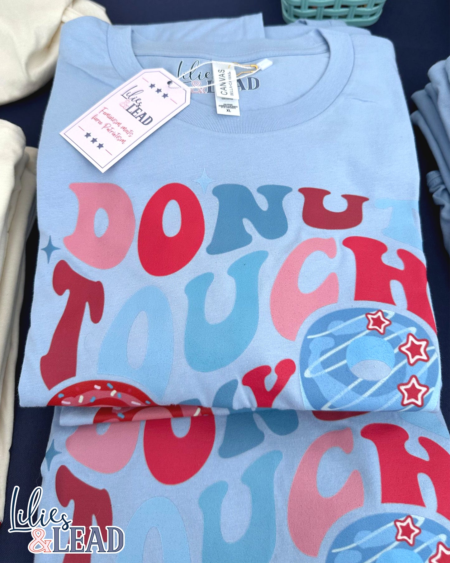 Baby blue tee with Donut Touch My Freedom printed in red, white, and blue with donut graphics.