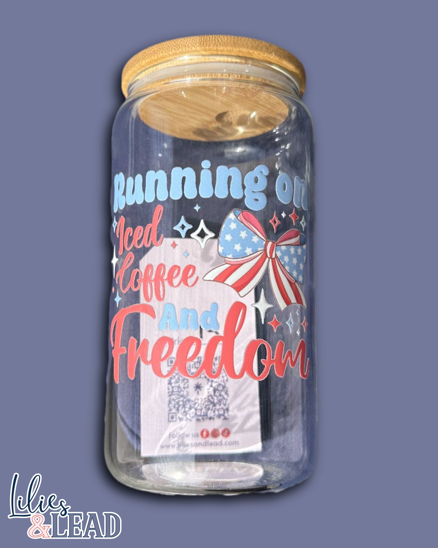 16oz glass can cup featuring the saying running on iced coffee and freedom with a patriotic bow and stars