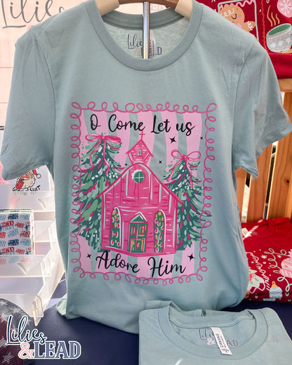 Light blue t-shirt with Christmas-themed graphic and text on a hanger.