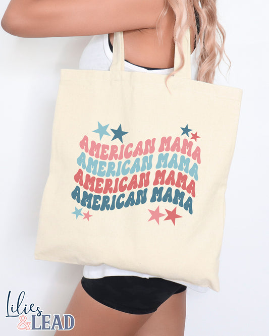 Canvas tote bag featuring American Mama repeated 4 times with retro font in red, white, and blue. 
