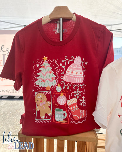 Red tee shirt featuring Christmas graphics on hanger