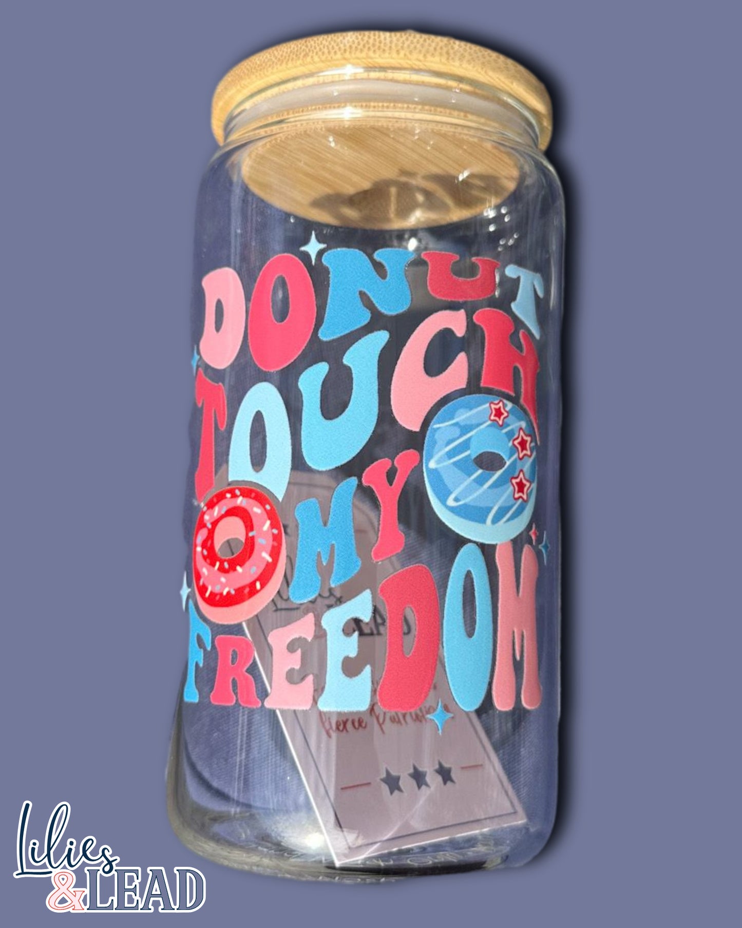 16oz glass can with retro font saying "donut touch my freedom" featuring donut graphics in variations of red, white and blue.