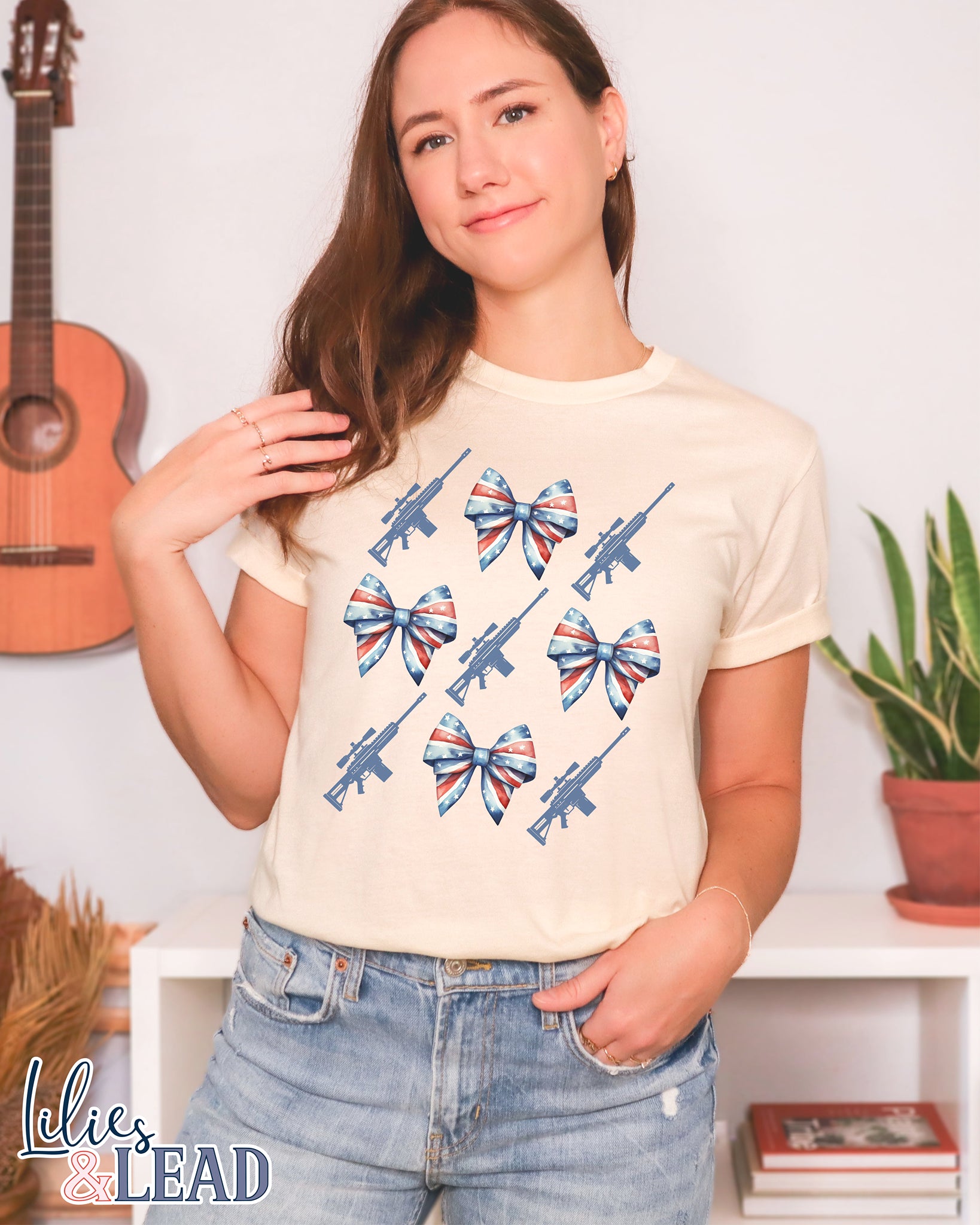 Tee shirt on model with patriotic bows and rifle detail