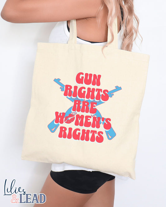 Canvas tote bag with Gun Rights Are Womens Rights in retro font, red and white. With Blue Rifles crossed in background