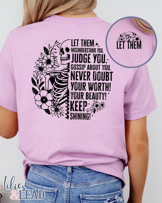 Lilac short sleeve tee with black skeleton and florals and the saying "Let them misunderstand you, judge you, gossip about you. Never doubt your worth! Your Beauty! Keep Shining!