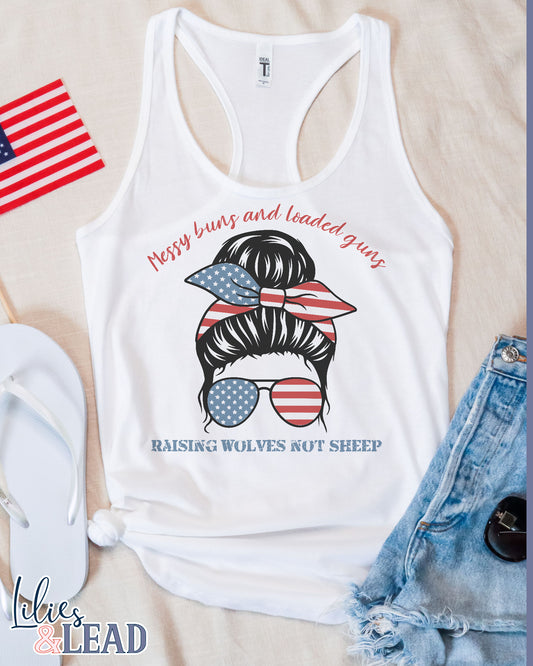 White Tank top with messy bun patriotic design that says messy buns and loaded guns raising wolves not sheep.