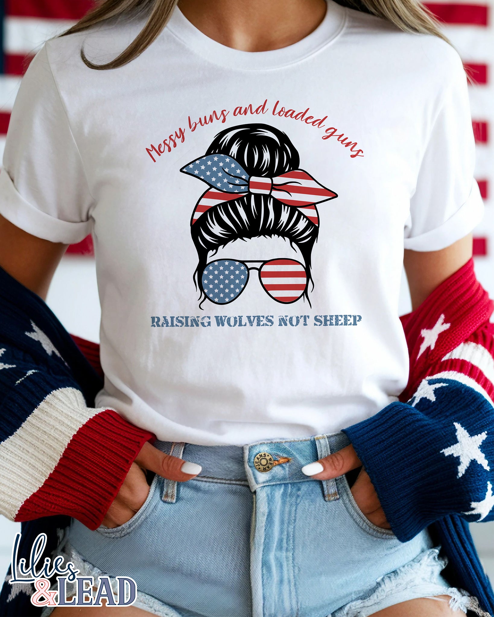 White tee shirt  on model with messy buns design wearing patriotic bandana and sunglasses featuring the phrase Messy buns and loaded guns raising wolves not sheep